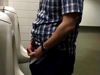 Uncut dick pissing at urinal