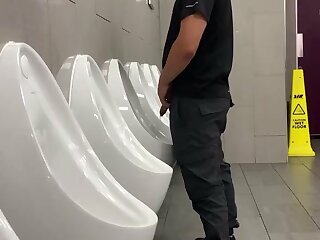 Uncut dick pissing at urinal