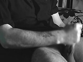 The boy jerks off close-up with a condom and cums loudly into it.