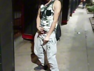 Young exhibitionist pulls out his hard cock and shows off to his friend in the middle off the street as people pass by--strokes, no cum