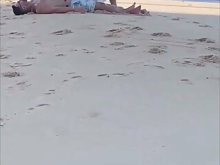 Guy letting a dude suck his cock on a populated public Beach In daylight with zero fucks given lol.