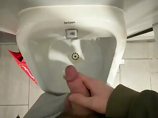 Jerking at the urinal.