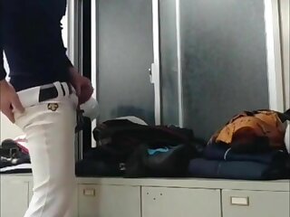 A male student wearing a baseball uniform ejaculates on the other's uniform.